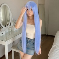 Model styling a light blue 40 inch long straight cosplay wig at a vanity