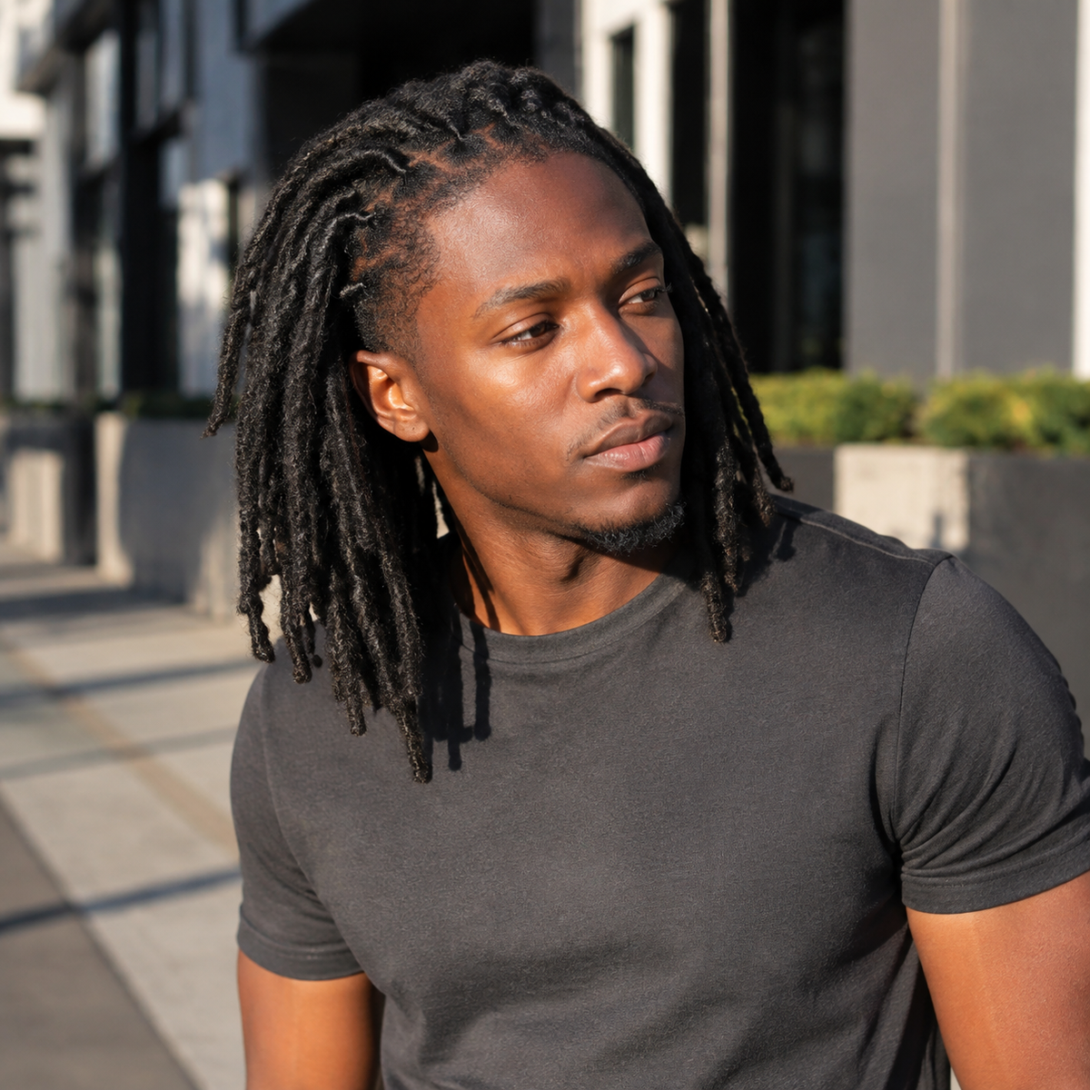Black man wearing natural black Afro Kinky loc extensions outdoors