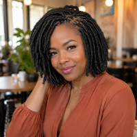 Black woman wearing a short Afro Kinky soft loc bob in a cafe