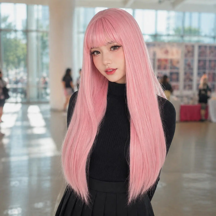 Model wearing pastel pink straight cosplay wig with bangs at convention