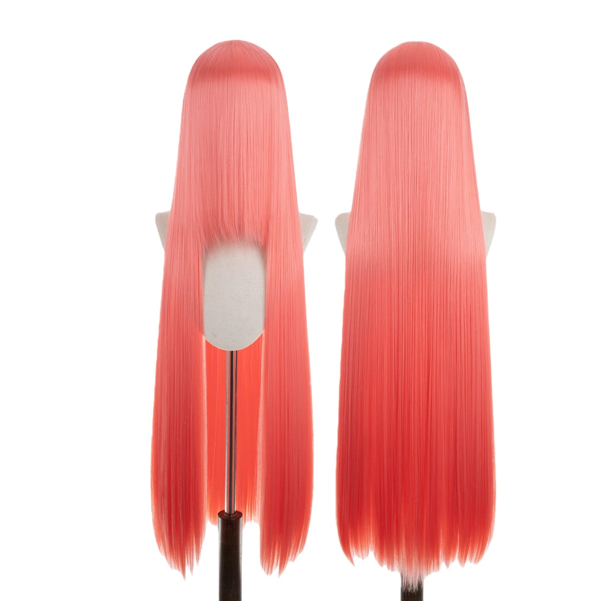 Two red wigs on mannequin heads against a white background